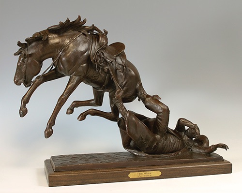 Bronze sculpture of cowboy bucked off his horse by Paul Moore
