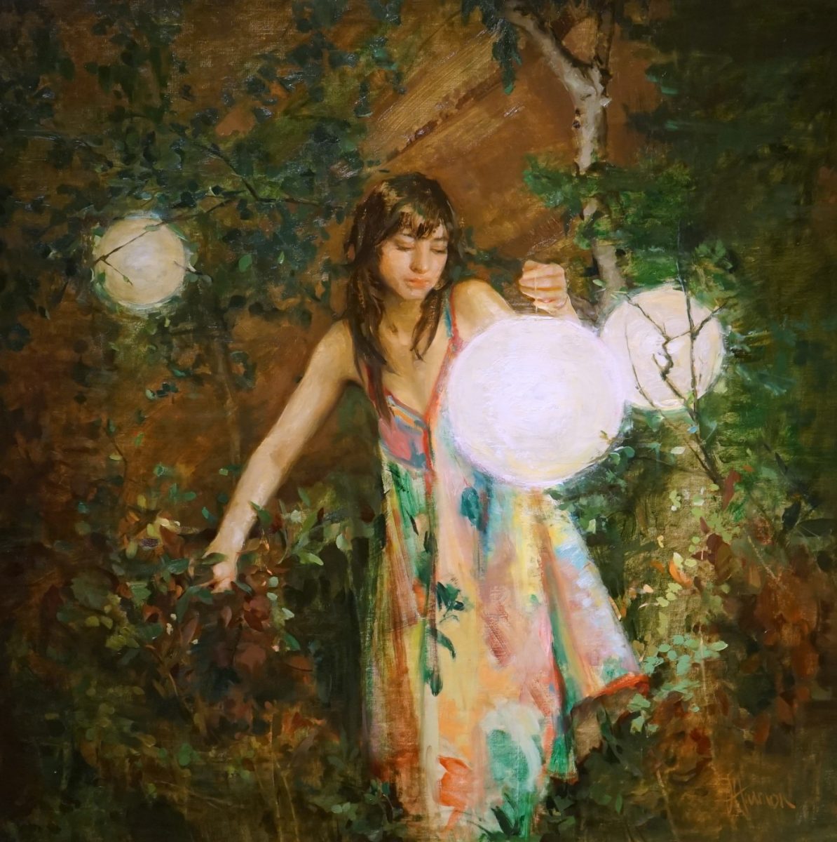 Portrait of woman in garden holding lanterns by Johanna Harmon